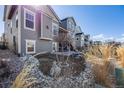 Charming backyard with tasteful landscaping and well maintained lawn in desirable suburban community at 671 Green Mountain Dr, Erie, CO 80516