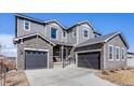 Attractive home featuring a two-car garage and appealing stone accents on the exterior at 671 Green Mountain Dr, Erie, CO 80516