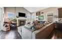 Inviting living room featuring a fireplace, hardwood floors, and ample natural light at 671 Green Mountain Dr, Erie, CO 80516