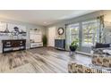 Bright and airy living room featuring wood floors, neutral walls, and large windows at 5316 S Rome St, Aurora, CO 80015