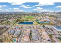 Scenic aerial view of a neighborhood, pond, recreational facilities and the city skyline in the distance at 5943 S Olive Cir, Centennial, CO 80111