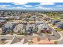 Beautiful aerial view of a suburban neighborhood with well-maintained homes, green spaces, and mountain views at 5943 S Olive Cir, Centennial, CO 80111