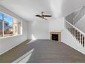 Spacious living room with a fireplace and large window at 6356 Blue Water Cir, Castle Rock, CO 80108