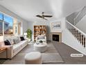 Virtually staged living room featuring a fireplace and comfortable seating at 6356 Blue Water Cir, Castle Rock, CO 80108