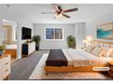 Virtually staged main bedroom with a large bed and en-suite bathroom at 6356 Blue Water Cir, Castle Rock, CO 80108