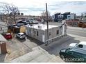 A compact building with a flat roof is nestled in a lot with parking and nearby access to city streets at 421 E Alameda Ave, Denver, CO 80209