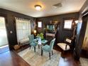 Inviting dining room with stylish decor, dark walls, and a glass-topped table set on a patterned rug at 421 E Alameda Ave, Denver, CO 80209