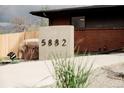 A close-up of the concrete address marker complemented by decorative rock and minimalist landscaping at 5882 W Chestnut Ave, Littleton, CO 80128