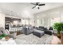 Bright, open-concept living room boasts a modern kitchen, dining area, and comfortable seating with lots of natural light at 6723 Raritan Dr, Denver, CO 80221
