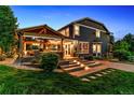 Backyard showcasing a covered patio with outdoor dining and lighting at 16267 W 59Th Pl, Golden, CO 80403