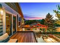 Deck view overlooking outdoor entertaining area with fire pit and sunset views at 16267 W 59Th Pl, Golden, CO 80403