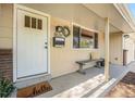 Inviting front entrance with a white door, decorative wreath, and a charming welcome mat at 8626 W Utah Ave, Lakewood, CO 80232
