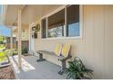 A cozy front porch with bench seating, decorative pillows, and a welcoming entrance at 8626 W Utah Ave, Lakewood, CO 80232