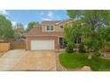 Traditional two-story home showcasing a neat lawn and an attached two-car garage at 10870 Crestone Needles Dr, Parker, CO 80138