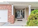Inviting front entryway with a secure screen door and traditional brick pillar at 10870 Crestone Needles Dr, Parker, CO 80138