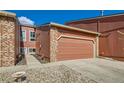 Exterior view of the home with a single car garage and brick and siding accents at 2923 W Bryant Cir, Littleton, CO 80120