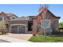 Charming home with stone accents, three-car garage, and beautiful landscaping at 6970 E Lake Dr, Centennial, CO 80111