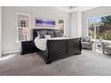 Spacious main bedroom featuring a trey ceiling, multiple windows, and a cozy sitting area at 6970 E Lake Dr, Centennial, CO 80111