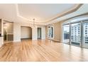 Expansive living area with hardwood floors, tray ceilings, and balcony access at 1827 N Grant St # 800, Denver, CO 80203