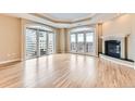 Large living area with a fireplace, hardwood floors, and views from the balcony at 1827 N Grant St # 800, Denver, CO 80203