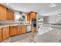 Kitchen boasts stainless appliances, knotty pine cabinets and granite countertops at 684 W 99Th Ave, Northglenn, CO 80260