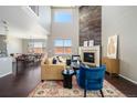 Bright living room showcasing a cozy fireplace with stylish decor and an adjacent dining area, perfect for entertaining at 13742 Valentia St, Thornton, CO 80602