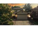 Charming home featuring a well-maintained lawn, mature trees, and a two-car garage at 10532 Madison St, Thornton, CO 80233