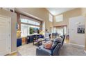 Bright living room boasting lots of natural light, tall ceilings, and comfortable seating at 10532 Madison St, Thornton, CO 80233