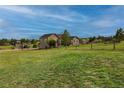 Expansive green lawn extending from the home's back, enclosed by a charming wooden fence at 2501 Remington Rd, Elizabeth, CO 80107