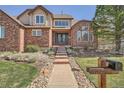 Beautiful brick two-story home with landscaped front yard and inviting entrance at 18971 E Pinewood Dr, Aurora, CO 80016