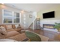 Living room features a modern fireplace and comfortable sectional sofa at 7880 Horsebrush Ln # A, Littleton, CO 80125