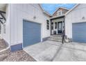 Attached two car garage with a cement driveway and decorative entryway at 4797 Saddle Iron Rd, Castle Rock, CO 80104