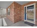 Stylish front entrance with a brick wall, a blue-trimmed storm door, and a textured doormat at 20567 E Weaver Dr, Aurora, CO 80016