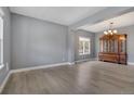 Open-concept living room featuring modern gray walls, light-colored floors, and a classic wooden cabinet at 20567 E Weaver Dr, Aurora, CO 80016