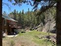 Spacious backyard featuring a patio, picnic area, solar panels, and a charming mountain home exterior at 72 Rudi W Ln, Golden, CO 80403