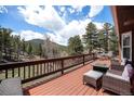 Inviting deck area with comfortable seating and a fire pit, perfect for relaxing and enjoying the view at 72 Rudi W Ln, Golden, CO 80403