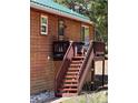 Stairs lead to a cozy deck with wood railings on a charming mountain home exterior at 72 Rudi W Ln, Golden, CO 80403