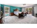 Spacious main bedroom features large windows, a decorative bed frame, and deck access at 72 Rudi W Ln, Golden, CO 80403