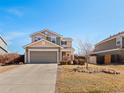 Charming two-story home with neutral siding, attached garage, and a well-maintained front yard at 896 Willow Dr, Brighton, CO 80603