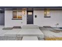 Modern front entry with gray door and updated light fixture at 1061 Elbert St, Denver, CO 80221