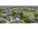 Expansive aerial view highlighting the neighborhood, surrounding landscaping, and a well maintained lawn at 16453 Homestead Ct, Parker, CO 80134