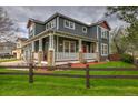Attractive gray home showcasing a lovely porch, well-kept lawn, and charming curb appeal at 16453 Homestead Ct, Parker, CO 80134