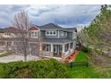 Charming two-story home boasting a cozy porch, complemented by lush green grass and tasteful landscaping at 16453 Homestead Ct, Parker, CO 80134