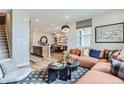 Open concept living area with comfortable seating, hardwood floors, and modern decor at 2475 W 69Th Pl, Denver, CO 80221