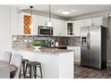 Modern kitchen with granite countertops and stainless steel appliances at 909 N Logan St # 6K, Denver, CO 80203