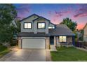 Charming two-story home with a well-manicured lawn and attached two-car garage at 9147 W Rockland Pl, Littleton, CO 80128