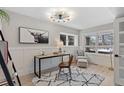 Inviting office space featuring a modern light fixture, stylish rug, and bright windows at 434 Clayton St, Denver, CO 80206