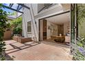 Outdoor patio with brick paving connects to the living room via sliding glass doors and provides private outdoor space at 434 Clayton St, Denver, CO 80206