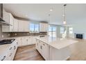 Modern kitchen featuring stainless appliances, large island and a beautiful view at 14131 Bunny Hop Ln, Parker, CO 80134
