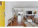 Inviting living room with hardwood floors, modern furnishings, and a bright yellow door at 2738 S Newton St, Denver, CO 80236